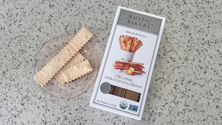 Olive Oil & Sel Gris Sourdough Flatbread on a plate with its packaging