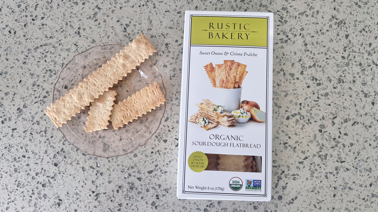 Sweet Onion & Creme Fraiche Sourdough Flatbread on a plate with its packaging