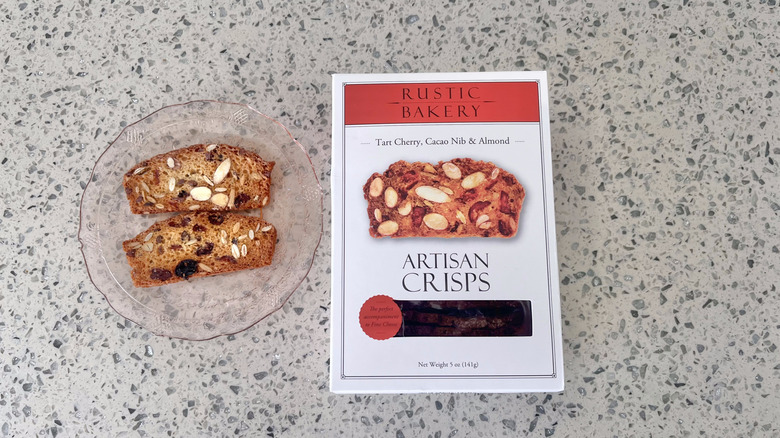 Cherry, Cacao Nib, & Almond Crisps on a plate with its packaging