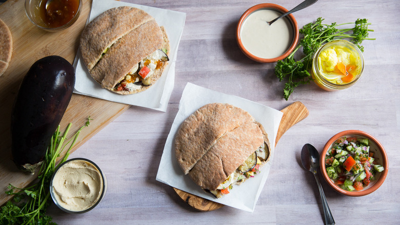 two sabich sandwiches on table