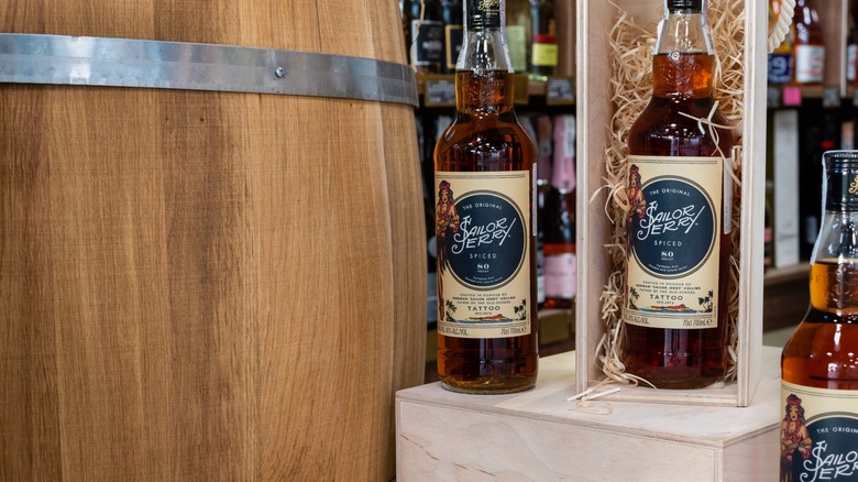 Bottles of Sailor Jerry rum next to a barrel