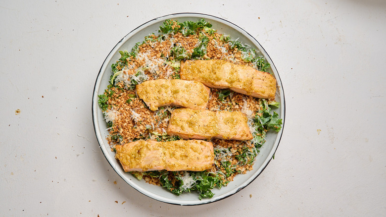 salmon on top of caesar salad