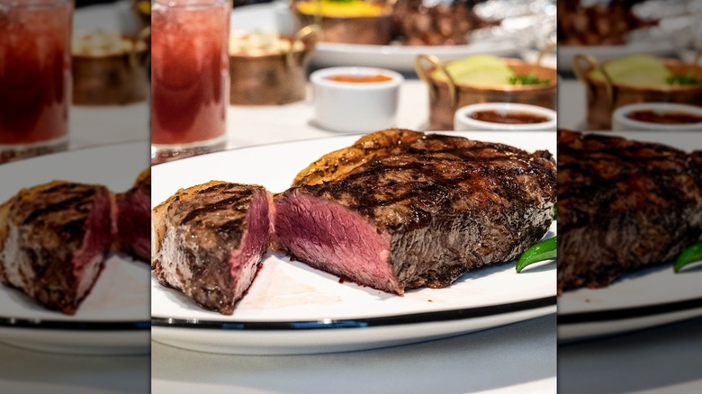 A steak sliced open on a white plate