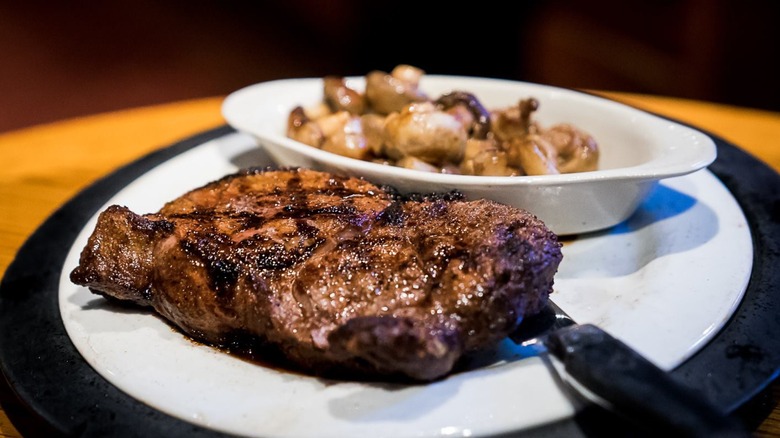 A grilled steak on a white plate