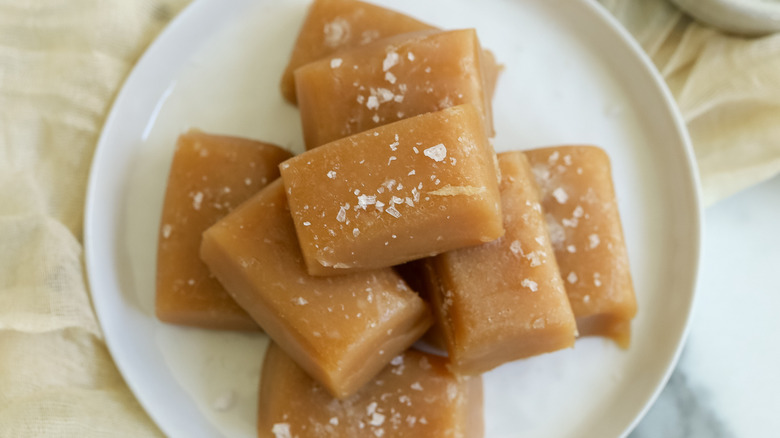 Salted caramel candies on a white plate