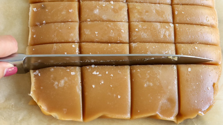 hand cutting caramel candies