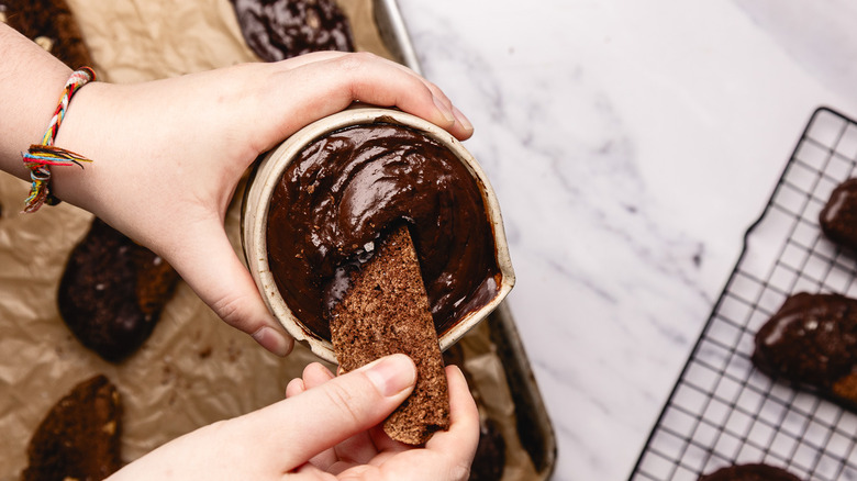 Dipping biscotti into ganache.
