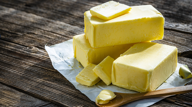 Stack of bright yellow butter blocks on top of a wrapping paper