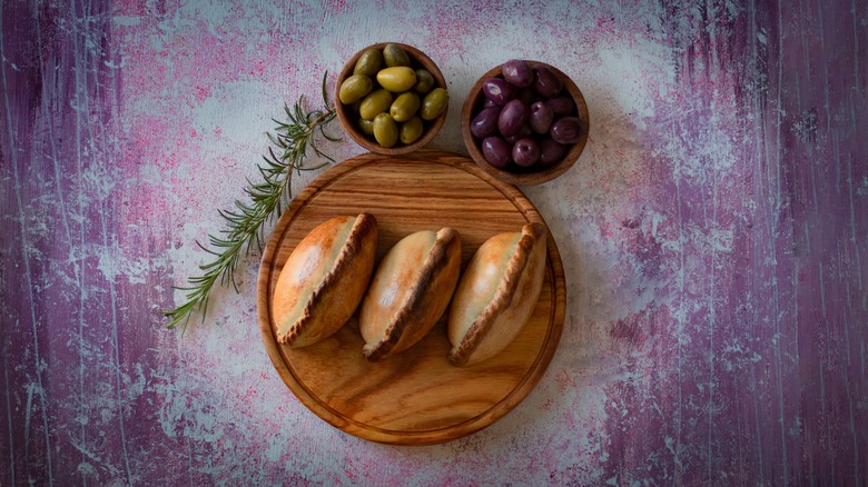 Three salteñas with olives