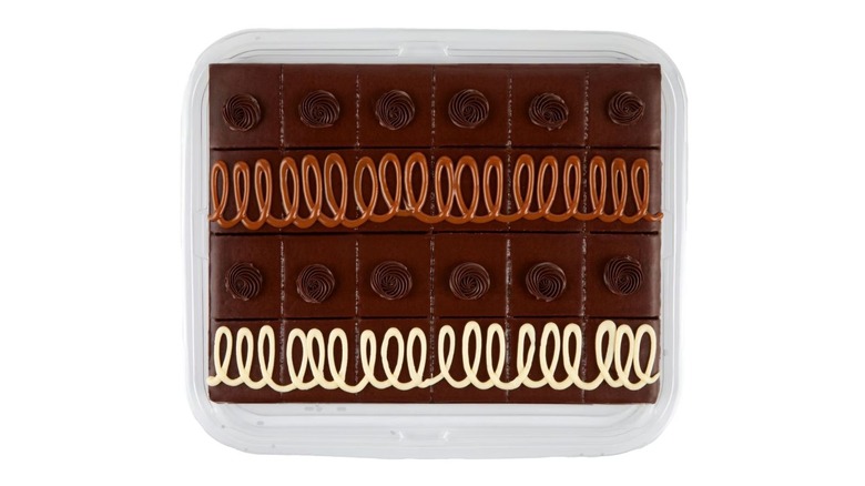 A tray of brownies decorated with brown and white icing on white background