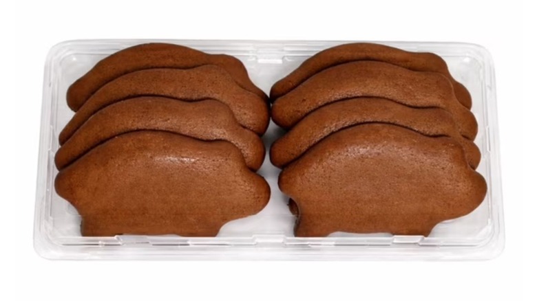 A pack of brown cookies in the shape of pigs on white background