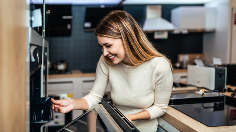 woman looking at kitchen appliance in store