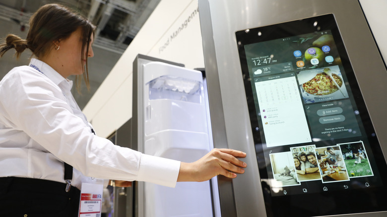 Person opening Samsung smart fridge.