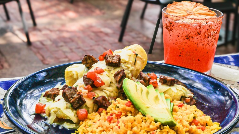 Plate of enchiladas and a red margarita on a table at La Fonda on Main