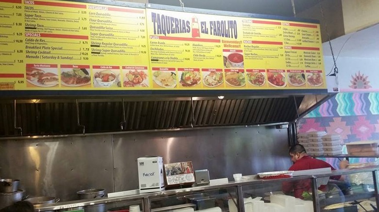 The menu posted above the counter at Taquerias El Farolito