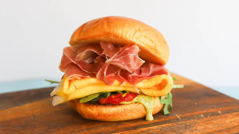 Pesto Prosciutto Breakfast Sandwich on wooden table