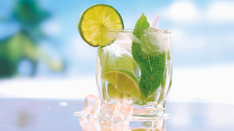 clear cocktail with lime garnish