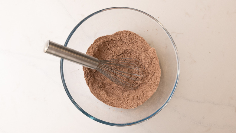 dry pancake ingredients in bowl with whisk inside