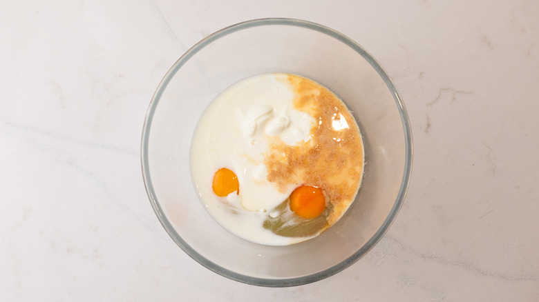 aerial view of glass bowl with wet pancake ingredients