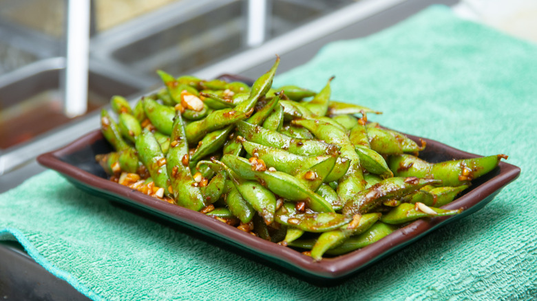 sauteed edamame on rectangular plate