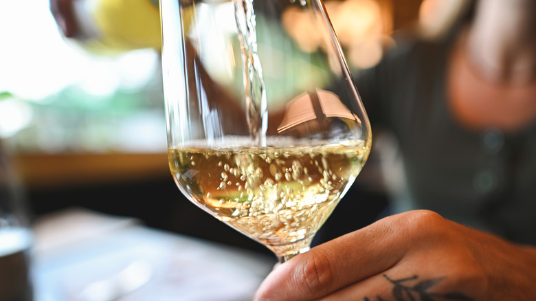 Glass of white wine in hand