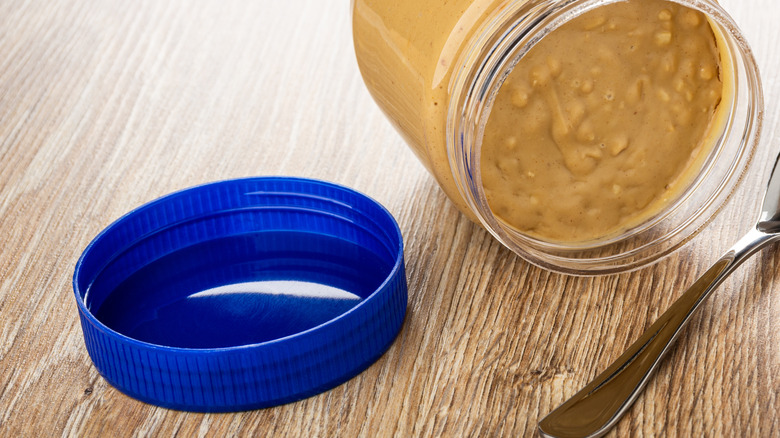 Peanut butter jar with blue lid