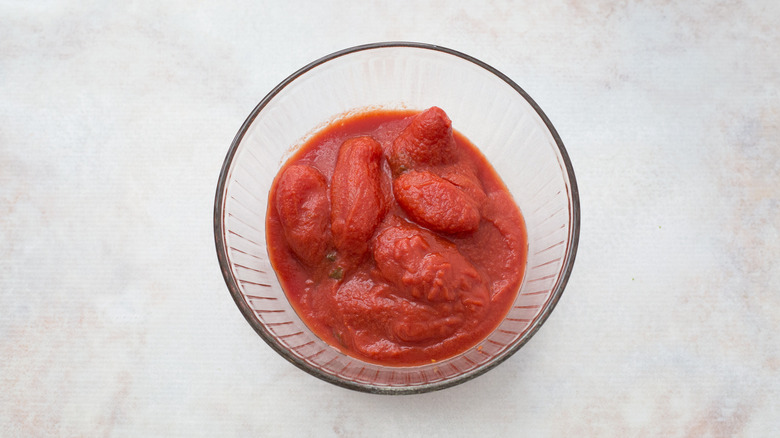 canned tomatoes in mixing bowl