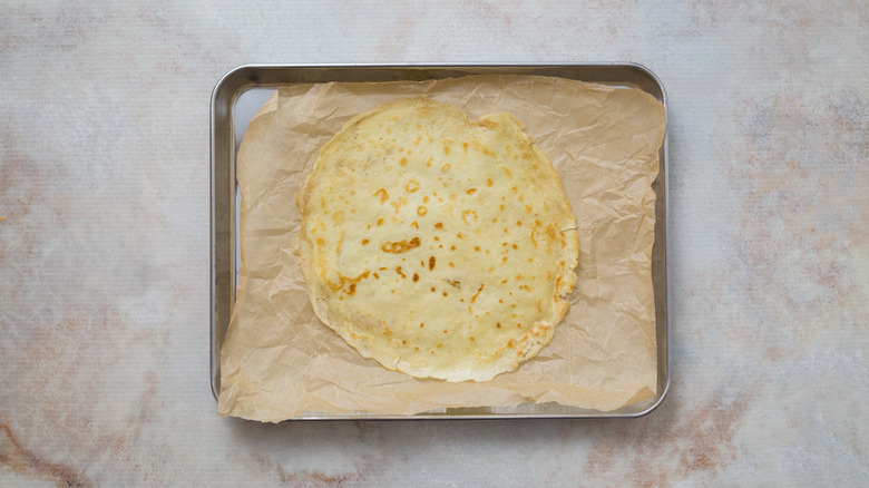 single crepe on baking sheet