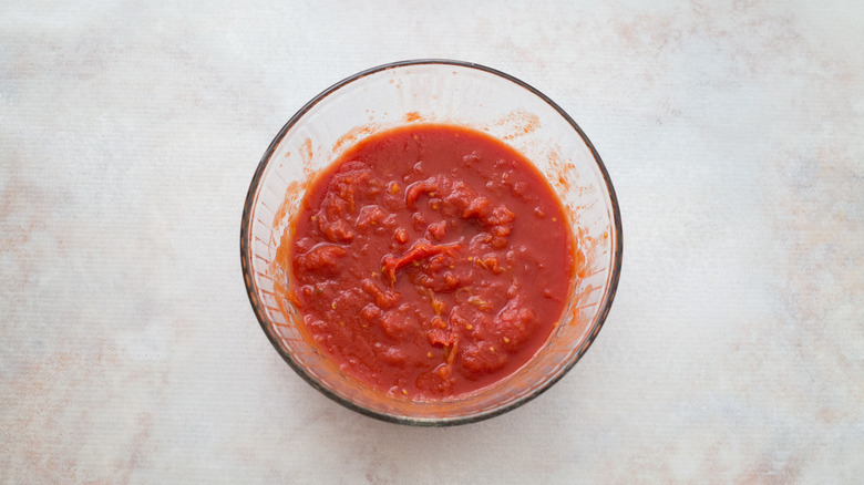 canned tomatoes in mixing bowl