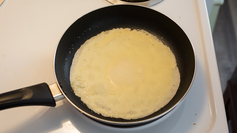 crepe cooking in frying pan
