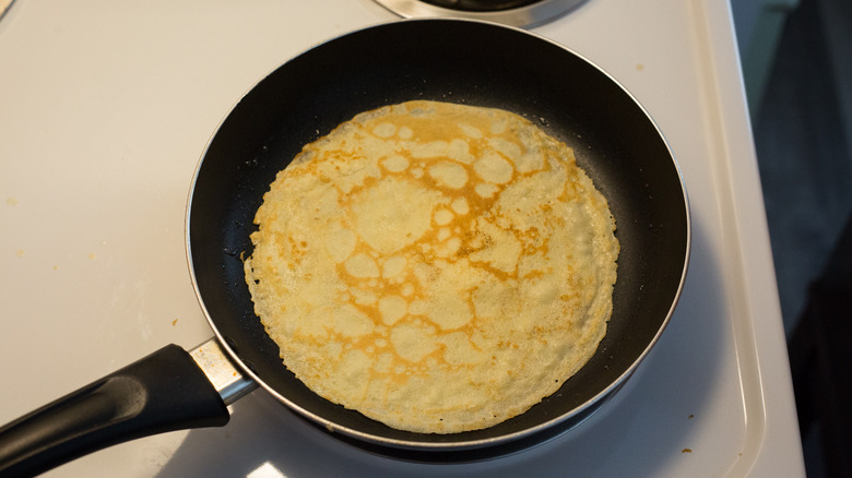 crepe cooking in frying pan