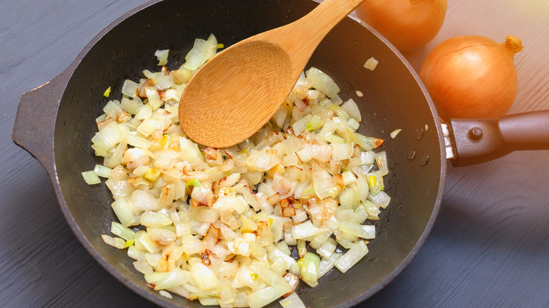 A pan full of steadily sauteing onions.