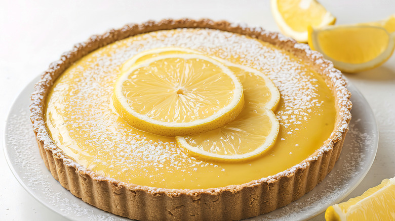 Lemon tart in a shell with lemon pieces