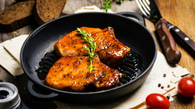 Pork chops cooking in a pan