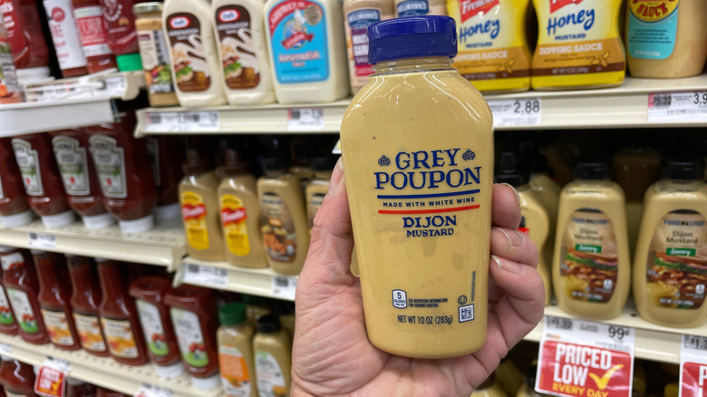 Grey Poupon mustard in a grocery aisle