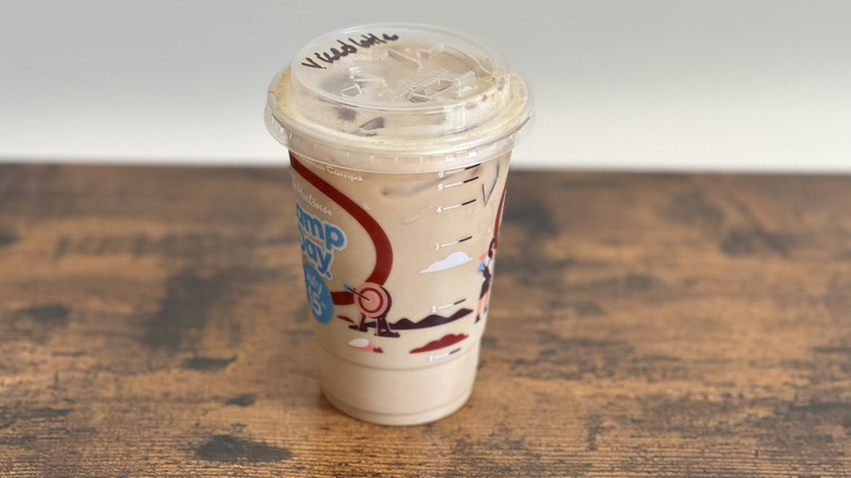 A cup of Tim Hortons vanilla iced latte on a wooden table