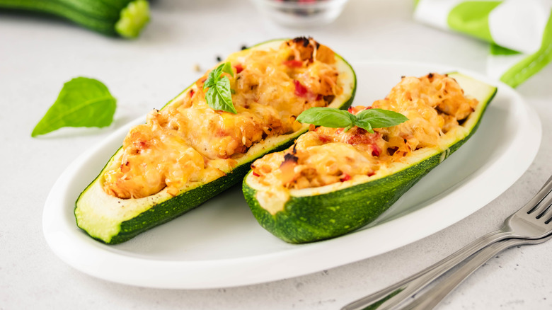 Two zucchini lasagna boats on a plate