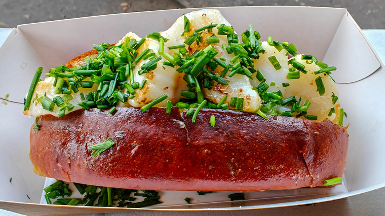 A scallop roll in a paper basket