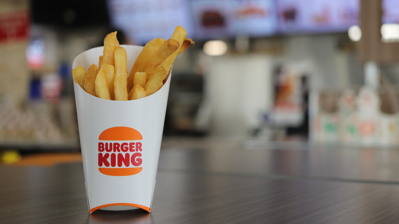 A pack of Burger King fries on a table in a restaurant