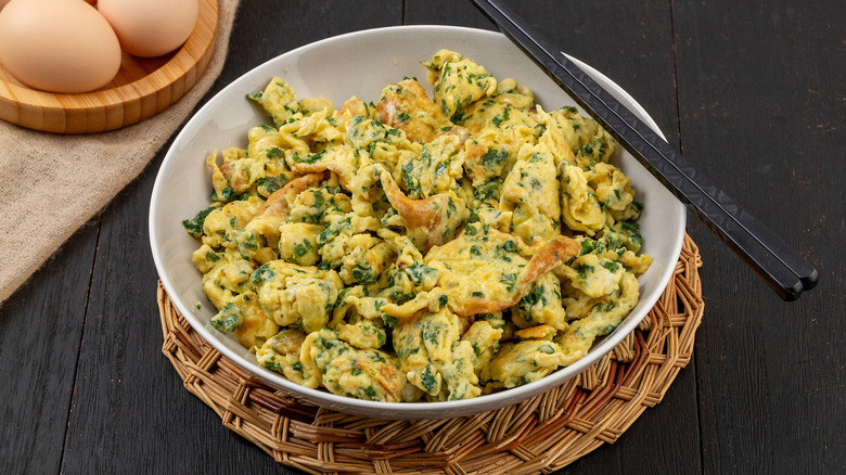 Scrambled eggs with kale and cheese.