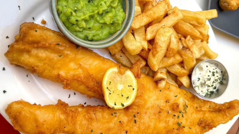 a traditional fish, chips and mushy peas dinner