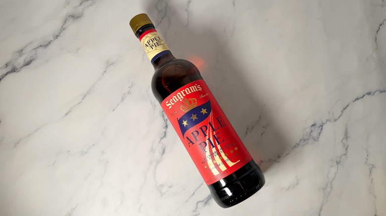 Top-down shot of bottle of Seagram's Apple Pie Whiskey lying down on marble surface