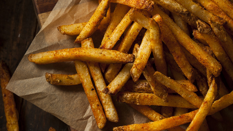 Seasoned fries on parchment paper