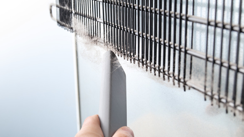 cleaning dust from fridge