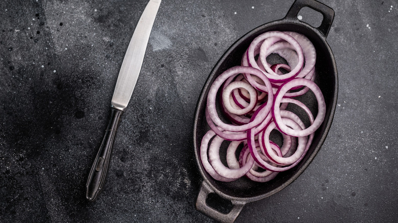 Red onion rings in black skillet