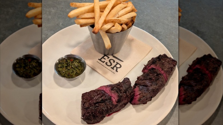 Hanger steak frites on white plate