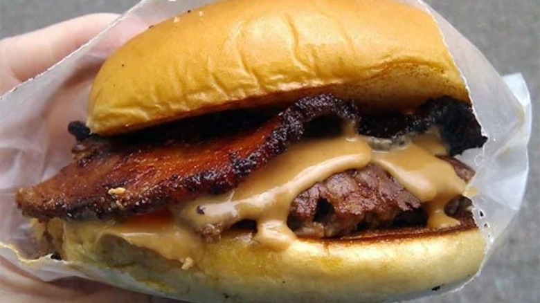 Burger wrapped in paper with bacon and peanut butter