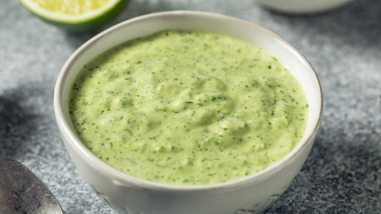 Bowl of lime mayo with green herbs