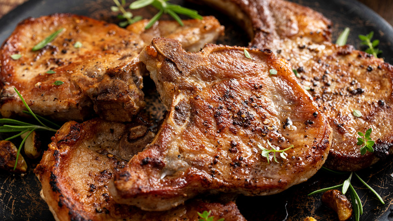Pork chops on a plate with herbs