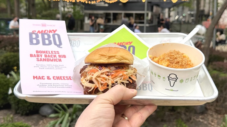 The Shake Shack BBQ Boneless Baby Back Rib Sandwich and Mac & Cheese held on a tray